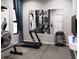 Well-equipped home gym featuring modern treadmill and weight set against mirrored wall at 4441 Pompano Se Dr, St Petersburg, FL 33705