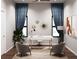 Modern home office featuring a large desk, comfortable chairs, and natural light at 4441 Pompano Se Dr, St Petersburg, FL 33705