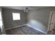 Bright bedroom with wood-look floors, ceiling fan, and ample closet space at 4614 Webster St, Tampa, FL 33610