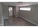 Spacious bedroom with wood-look floors and access to another room at 4614 Webster St, Tampa, FL 33610