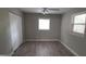 Bedroom with double closets, wood-look floors, and neutral color scheme at 4614 Webster St, Tampa, FL 33610