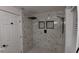 Modern shower with marble tile and rainfall shower head at 4614 Webster St, Tampa, FL 33610