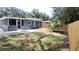 Nice backyard with patio, wooden fence, and tropical plantings at 4614 Webster St, Tampa, FL 33610