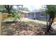 Spacious backyard featuring a lush lawn, wooden fence, and mature trees at 4614 Webster St, Tampa, FL 33610