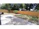 Large backyard featuring a patio, wooden fence, and mature trees at 4614 Webster St, Tampa, FL 33610