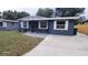 Inviting single-story home featuring tidy front yard and cozy front porch at 4614 Webster St, Tampa, FL 33610