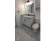 Bathroom with granite vanity and white fixtures at 4614 Webster St, Tampa, FL 33610