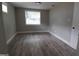 Spacious bedroom with neutral walls, wood-look floors, and large window at 4614 Webster St, Tampa, FL 33610