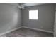 Cozy bedroom with grey walls, wood-look floors, and ceiling fan at 4614 Webster St, Tampa, FL 33610
