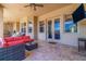 Covered patio features comfortable seating and overlooks the pool at 10200 Shooting Star Ct, New Port Richey, FL 34655