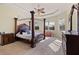 Main bedroom with a large four-poster bed and ample natural light at 10200 Shooting Star Ct, New Port Richey, FL 34655