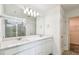 Modern bathroom with double vanity, large mirror, and walk-in shower at 10316 Cross River Trl, Parrish, FL 34219