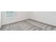 Bright bedroom with plush carpeting, white walls, and a window allowing natural light at 10316 Cross River Trl, Parrish, FL 34219