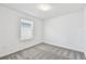 Cozy bedroom features gray carpet, a window with blinds, and neutral walls at 10316 Cross River Trl, Parrish, FL 34219