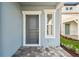 Welcoming entryway featuring a gray front door and a decorative sidelight window at 10316 Cross River Trl, Parrish, FL 34219