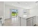 Spacious kitchen with a large island, sliding glass doors to the backyard and tile flooring at 10316 Cross River Trl, Parrish, FL 34219