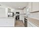 Bright kitchen with white cabinets, stainless steel appliances, and tile backsplash at 10316 Cross River Trl, Parrish, FL 34219