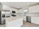 Open kitchen with white cabinets, stainless steel appliances, and a quartz countertop island at 10316 Cross River Trl, Parrish, FL 34219