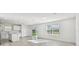 Open-concept living area with tile flooring, abundant natural light, and modern finishes at 10316 Cross River Trl, Parrish, FL 34219