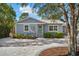 Charming light blue house with a paved driveway and nicely landscaped yard at 1521 Gray S St, Gulfport, FL 33707