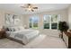 Spacious bedroom with ceiling fan and large windows offering garden views at 16183 Colchester Palms Dr, Tampa, FL 33647