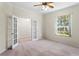 Neutral-toned home office featuring French doors and a window at 16183 Colchester Palms Dr, Tampa, FL 33647