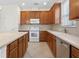 Kitchen features wood cabinets, stainless steel appliances and tile flooring at 16183 Colchester Palms Dr, Tampa, FL 33647