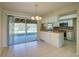 Bright kitchen with white cabinets, tile floor, and view of backyard at 18138 Lake Worth Blvd, Port Charlotte, FL 33948