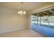 Bright dining room with tiled floor and sliding glass doors to a patio at 18138 Lake Worth Blvd, Port Charlotte, FL 33948