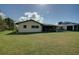 Large backyard with a grassy area and screened patio at 18138 Lake Worth Blvd, Port Charlotte, FL 33948
