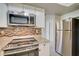 Stainless steel appliances and granite countertops in a renovated kitchen at 18138 Lake Worth Blvd, Port Charlotte, FL 33948