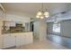 Open concept kitchen with white cabinets and view of living room at 18138 Lake Worth Blvd, Port Charlotte, FL 33948