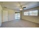 Main bedroom with ceiling fan and sliding glass doors to patio at 18138 Lake Worth Blvd, Port Charlotte, FL 33948