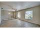 Open living area with neutral walls, tile floors, and large windows at 18138 Lake Worth Blvd, Port Charlotte, FL 33948