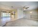 Spacious living room featuring wood-look tile flooring and ceiling fan at 18138 Lake Worth Blvd, Port Charlotte, FL 33948