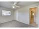 Bright bedroom with ceiling fan, window, and access to bathroom at 18138 Lake Worth Blvd, Port Charlotte, FL 33948