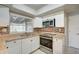 Modern kitchen with white cabinets, granite counters, and stainless steel appliances at 18138 Lake Worth Blvd, Port Charlotte, FL 33948