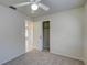 Bedroom with ceiling fan, neutral walls, and carpeted floor at 18138 Lake Worth Blvd, Port Charlotte, FL 33948