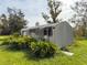 Rustic metal shed nestled in a lush green landscape at 19234 Causeway Blvd, Land O Lakes, FL 34638