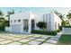 Modern house with white walls, gray accents, and a two car garage at 19234 Causeway Blvd, Land O Lakes, FL 34638