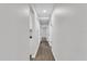 Clean hallway with light gray walls and wood-look flooring at 2623 W Tyson Ave, Tampa, FL 33611