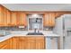 Updated kitchen with wood cabinets and stainless steel appliances at 3078 Eastland Blvd # 304, Clearwater, FL 33761