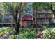 Exterior view of a condo building with lush landscaping at 3078 Eastland Blvd # 304, Clearwater, FL 33761