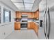 Updated kitchen with wood cabinets and stainless steel appliances at 3078 Eastland Blvd # 304, Clearwater, FL 33761