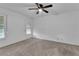 Spacious bedroom featuring a ceiling fan and large windows at 3078 Eastland Blvd # 304, Clearwater, FL 33761