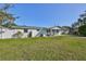 Newly renovated home with a spacious front yard and modern curb appeal at 3207 Acacia St, Lutz, FL 33558