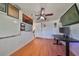 Home office featuring wood floors, standing desk, and ample storage at 3207 Acacia St, Lutz, FL 33558