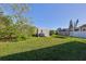 Backyard with grassy area, shed, and trampoline at 3207 Acacia St, Lutz, FL 33558