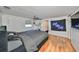 Spacious bedroom with large bed, hardwood floors, and a ceiling fan at 3207 Acacia St, Lutz, FL 33558