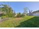 Large backyard with a shed and trampoline, offering ample outdoor space at 3207 Acacia St, Lutz, FL 33558